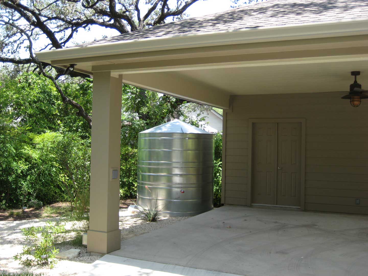 galvanized metal cistern by garage