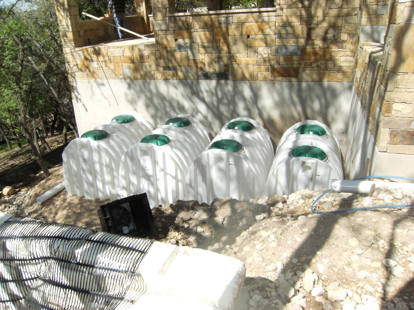 four 1500 gallon underground poly tanks