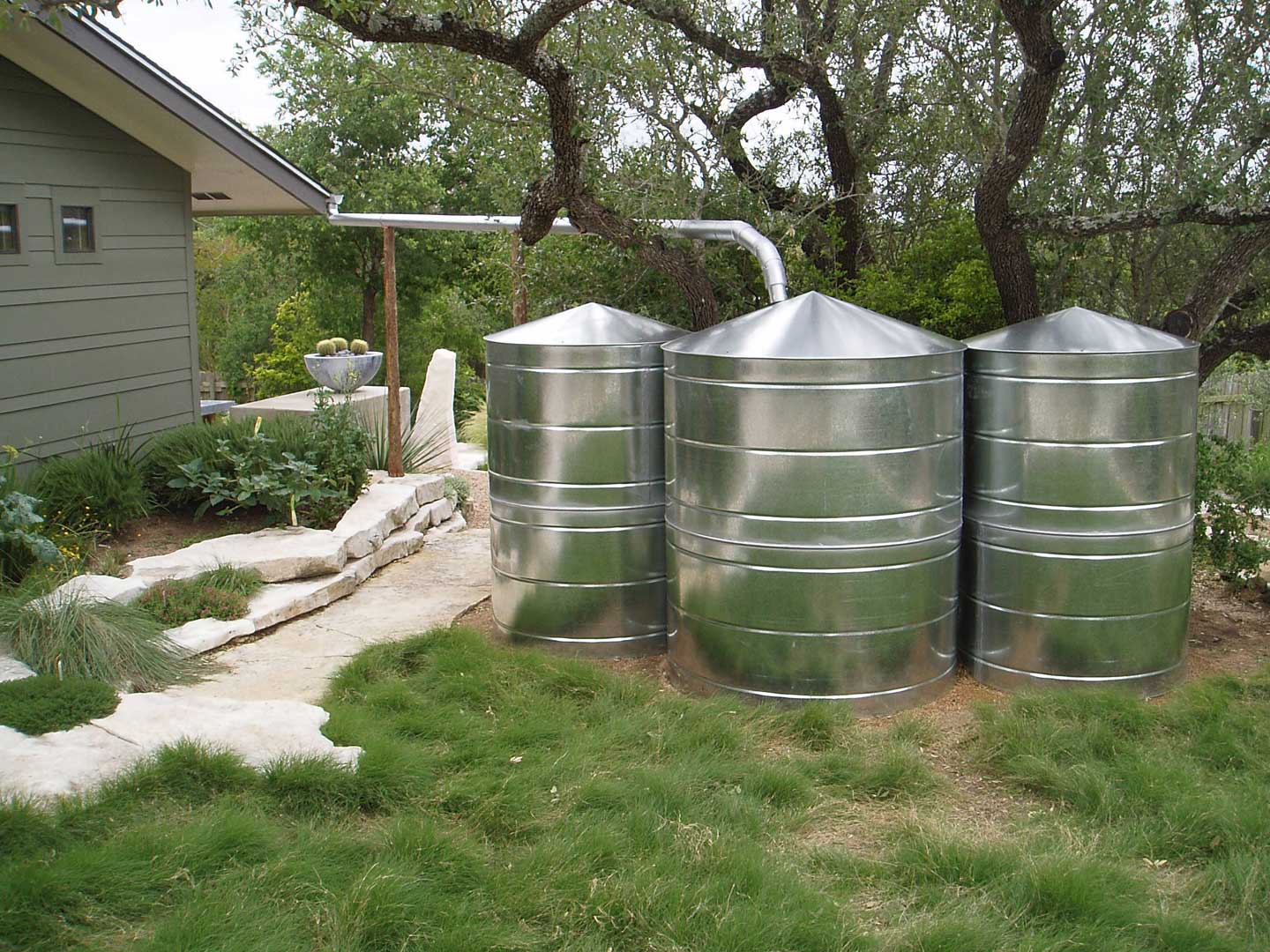 three galvanized metal cisterns